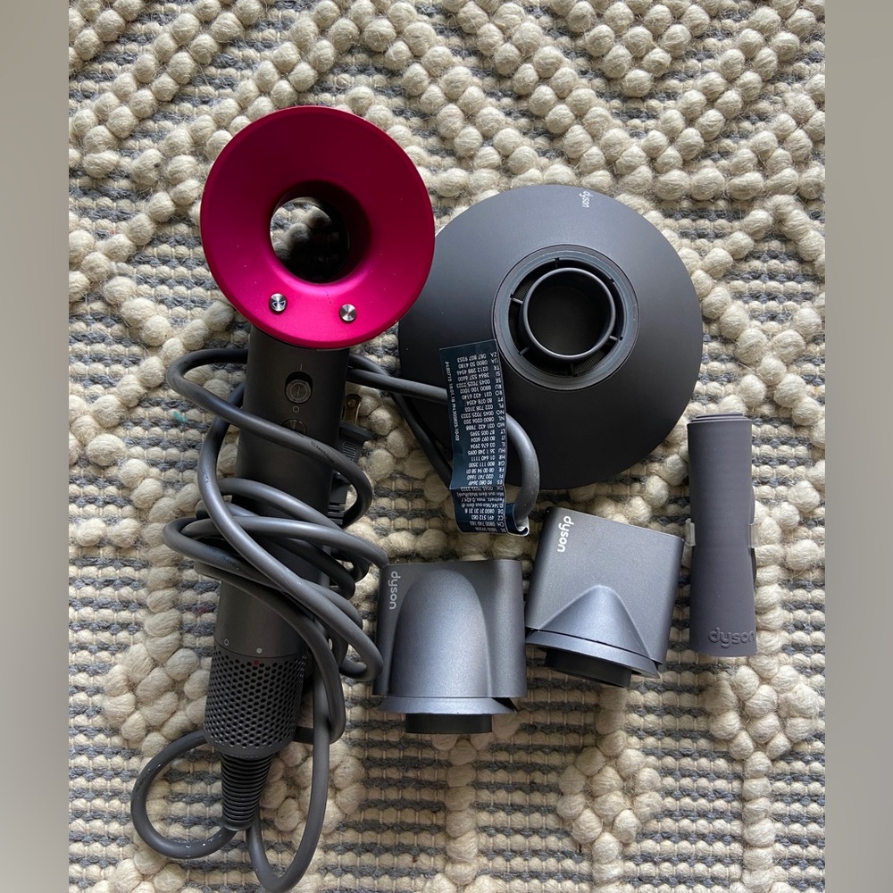Dyson Hairdryer with attachments. Mint condition. Proactive film partially on